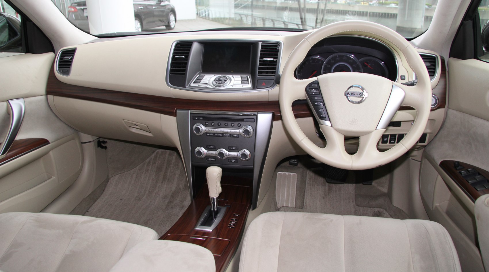 Beige interior with wood trim and ergonomic dashboard and center console
