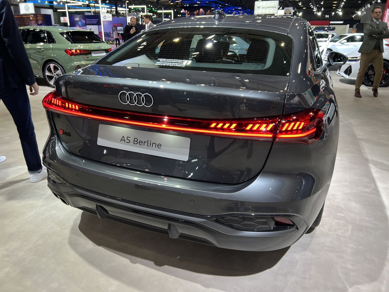 Rear view of a sedan featuring continuous LED taillight strip and sporty rear diffuser.