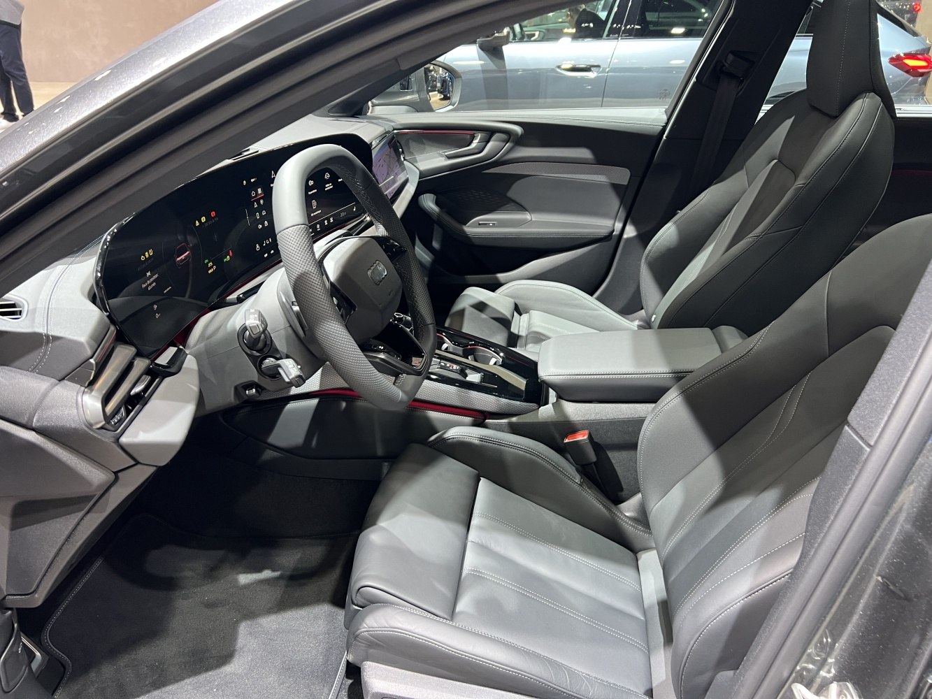 Modern car interior featuring digital cockpit and leather seats