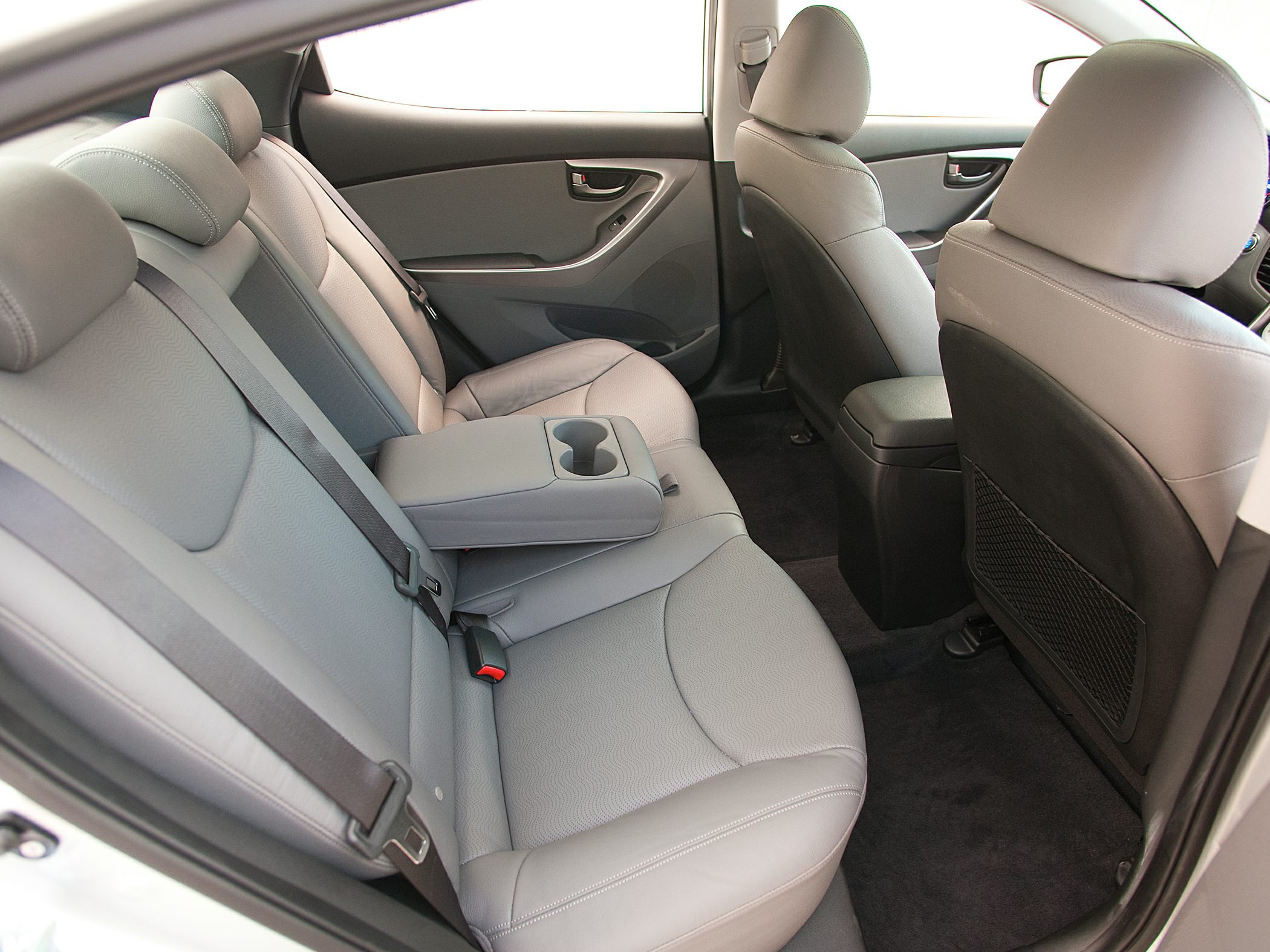Rear seat interior with fold-down armrest and cup holders