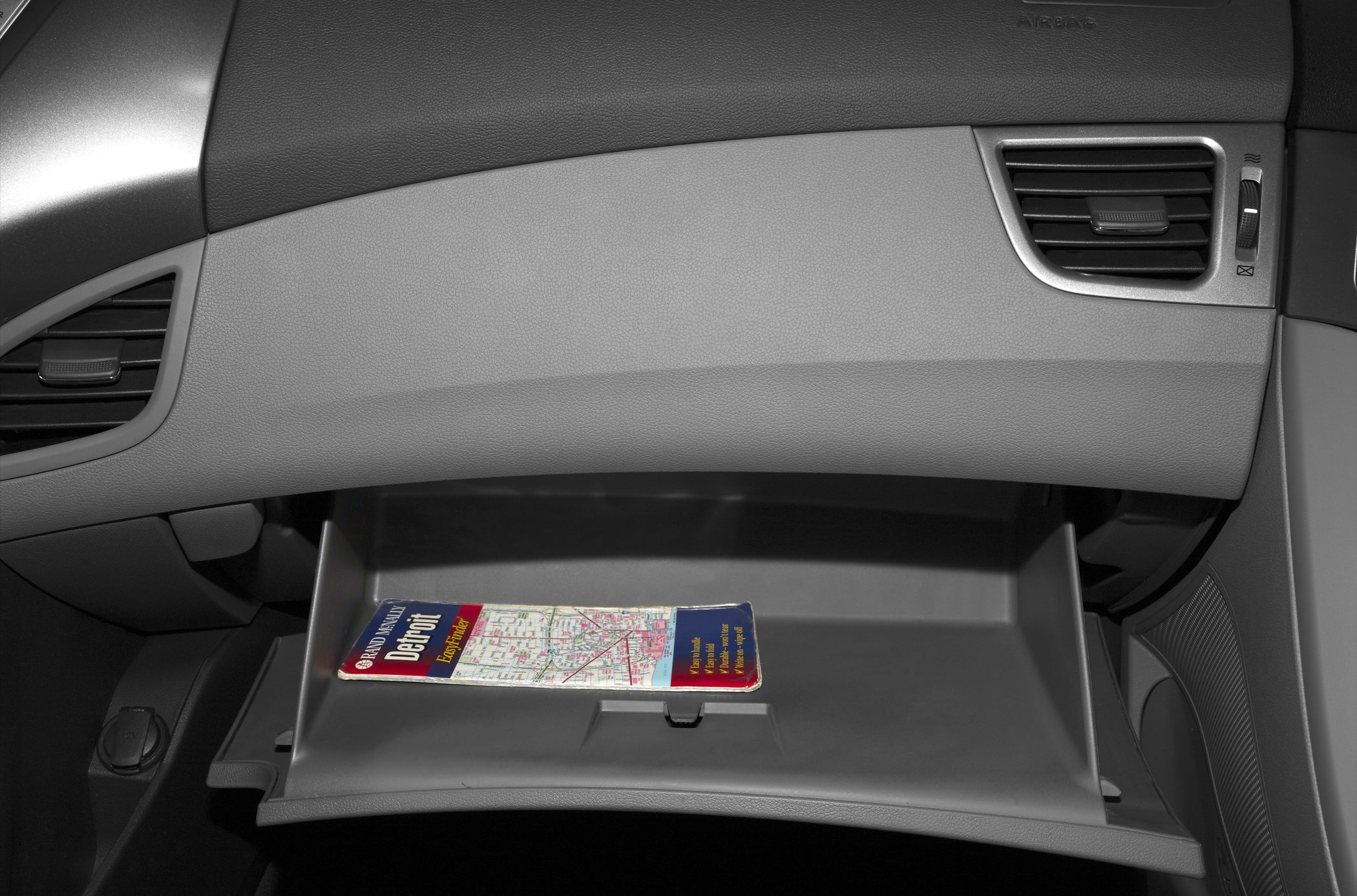 Open glove compartment with vent and storage space