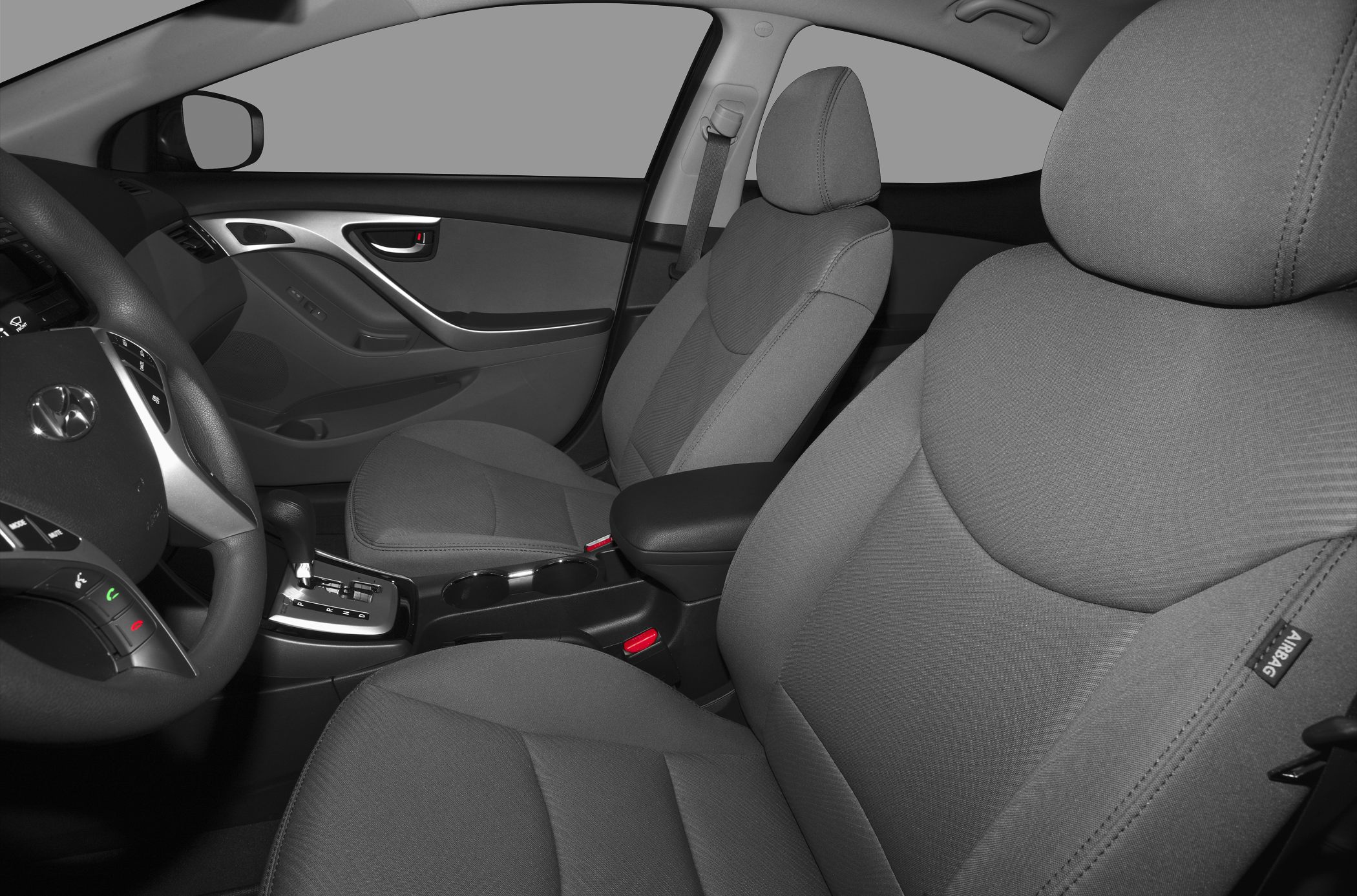 Front fabric seats and car dashboard with steering wheel and gear shift