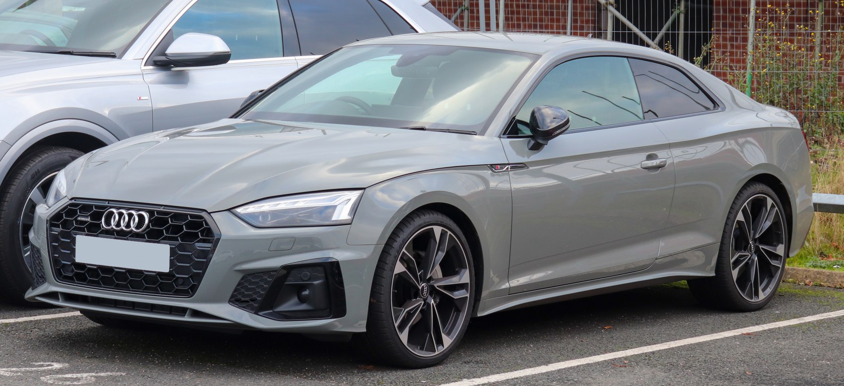 Front view with LED headlights, honeycomb grille and alloy wheels.