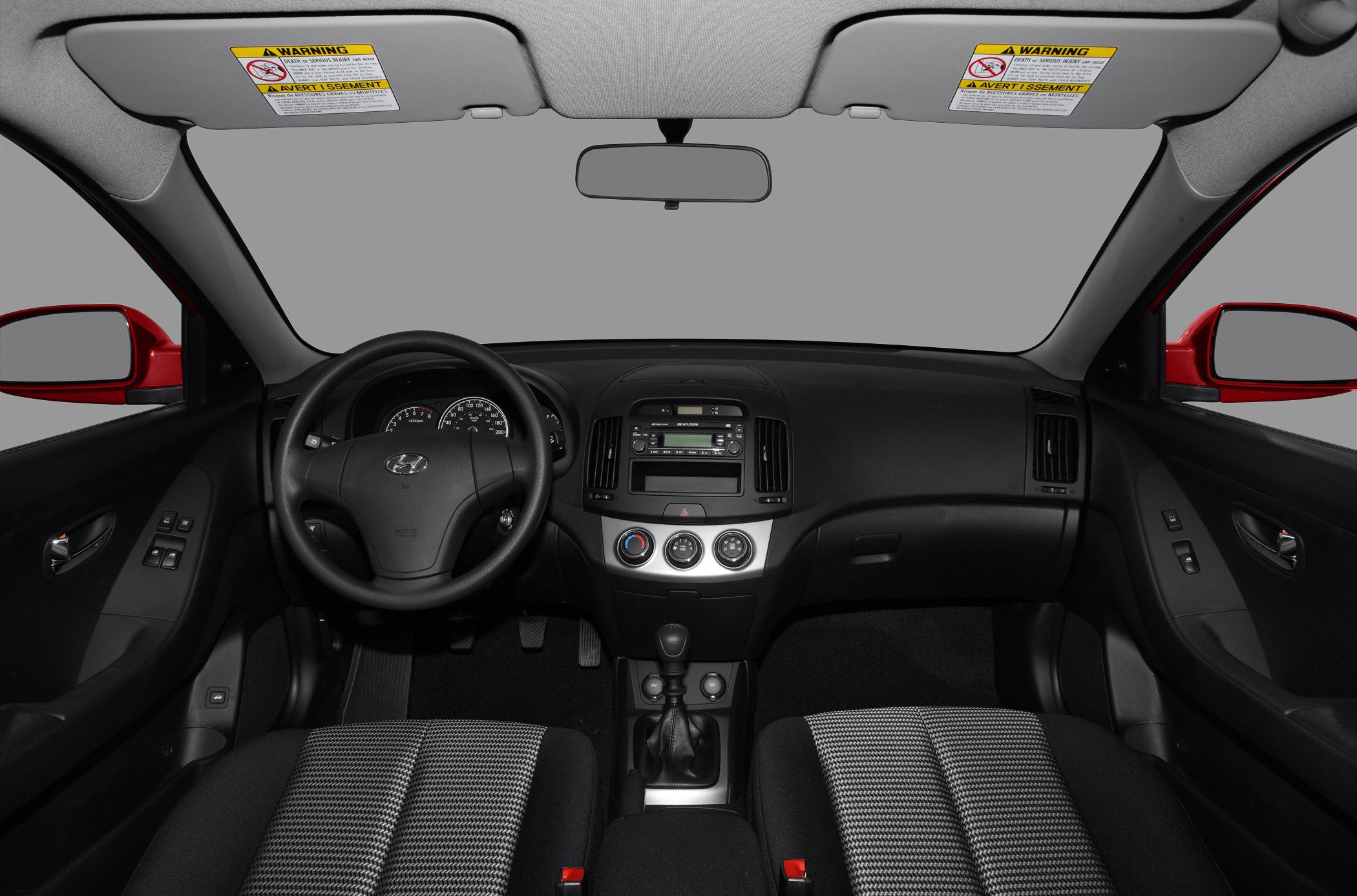 Dashboard and manual transmission interior with steering wheel and climate controls