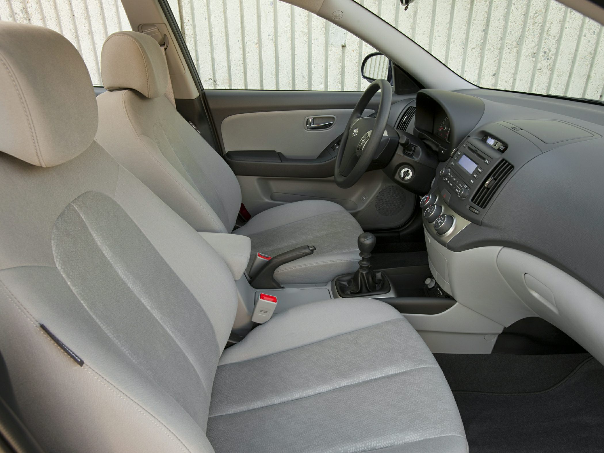 Front seats and dashboard with manual gear shift in car interior