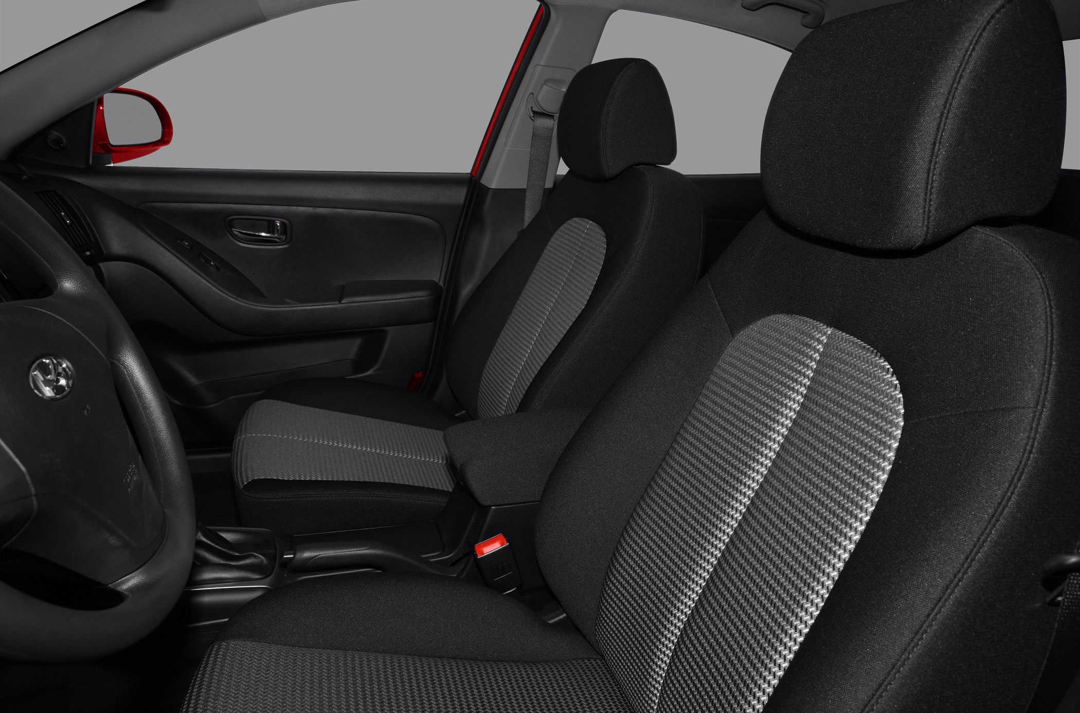 Front seats and driver's door panel of a car interior.