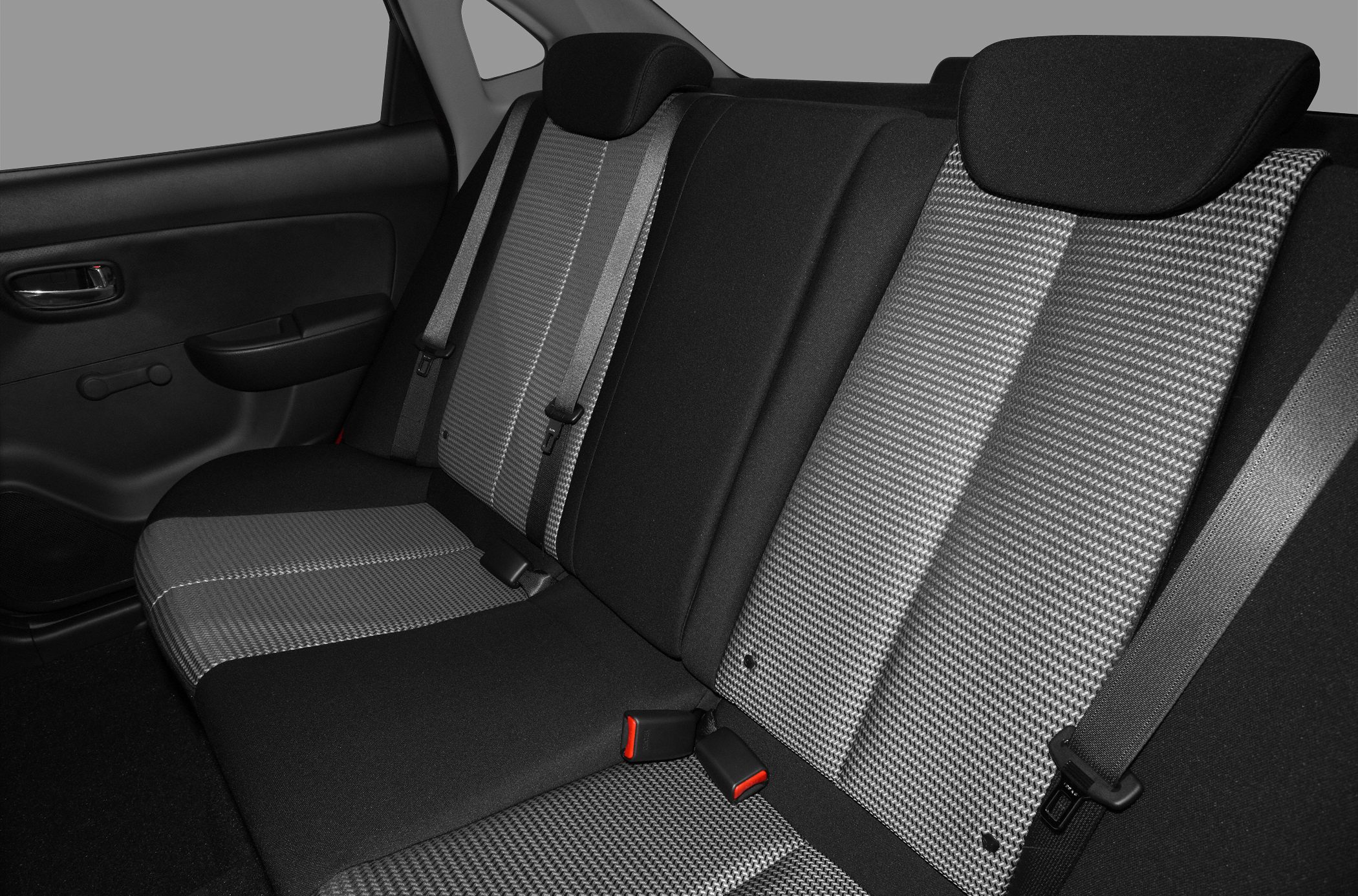 Rear seat with patterned fabric upholstery and seatbelts