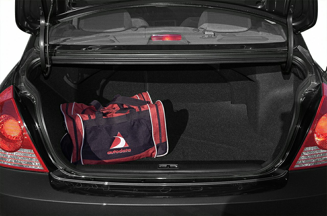 Open trunk interior with spacious cargo area and a bag inside