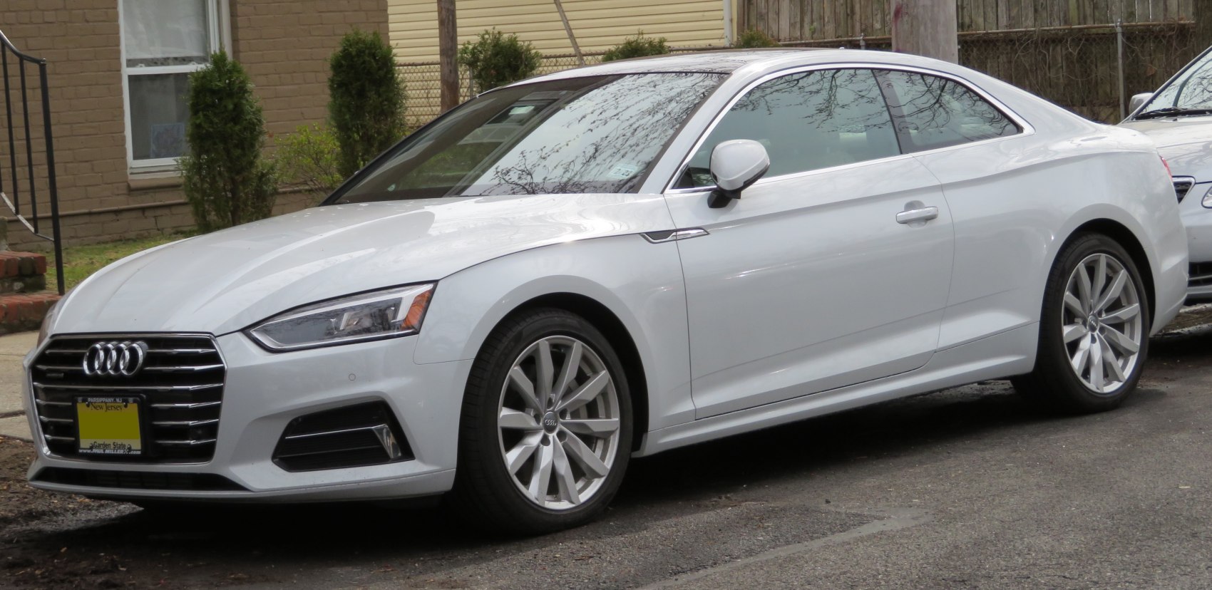Silver coupe with sleek front side profile and alloy wheels