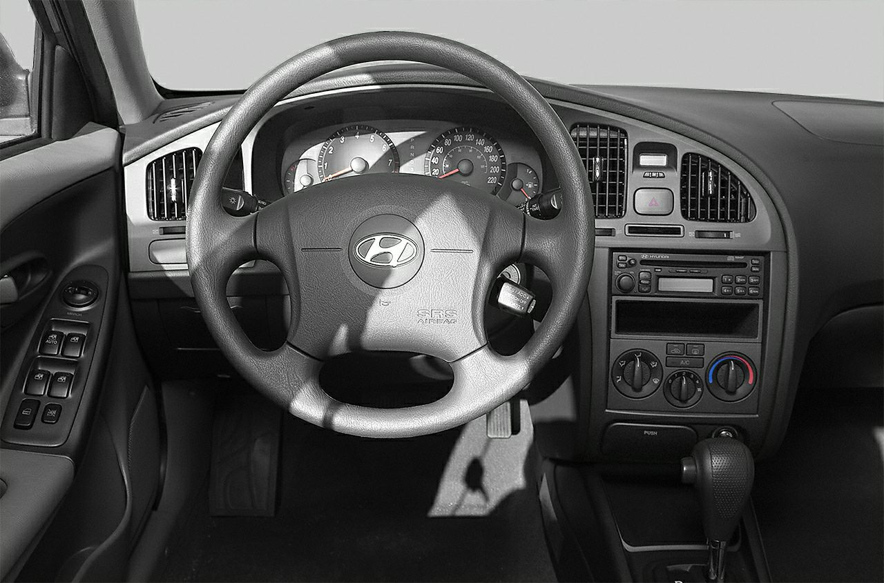 Dashboard with steering wheel, gauges, air vents, and center console controls.