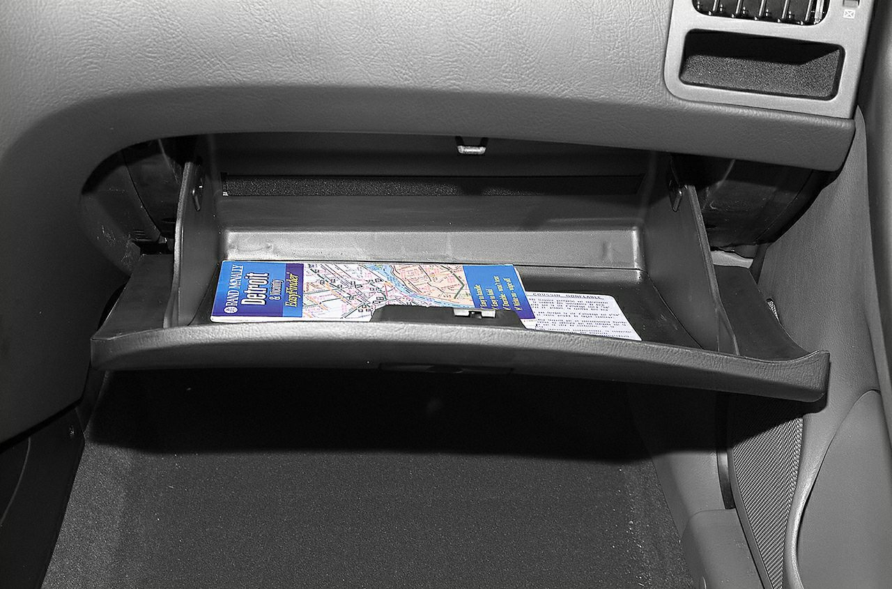 Open glove compartment with folded map inside