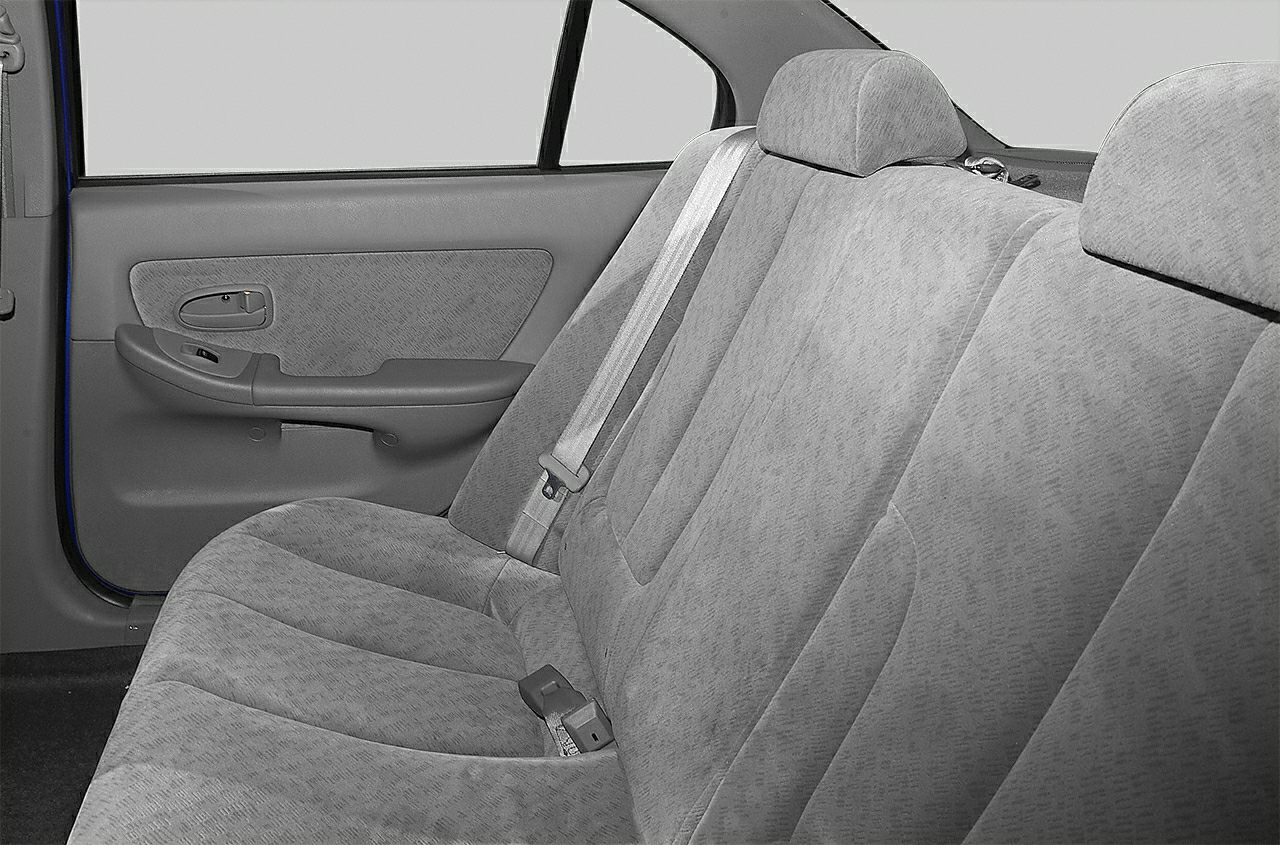 Fabric rear seating with integrated headrests and seatbelt on sedan door side