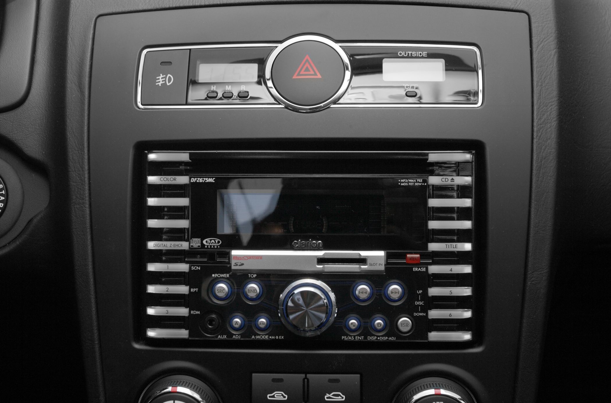 Car dashboard center console with Clarion stereo and control buttons