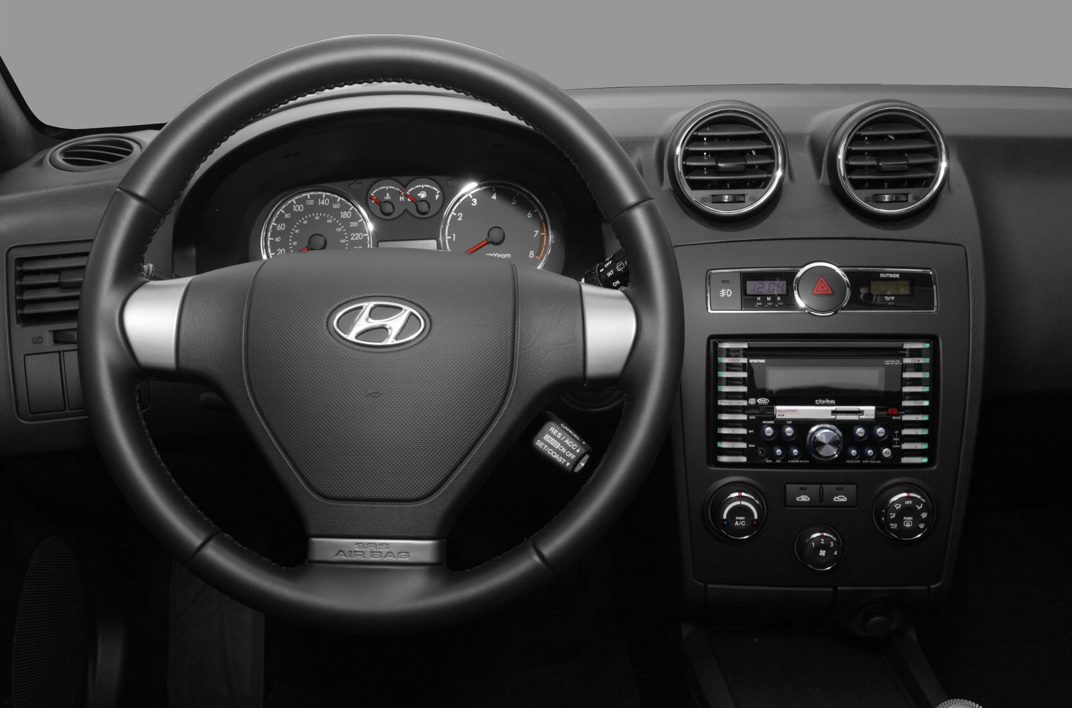 Steering wheel and dashboard with instrument cluster and climate controls