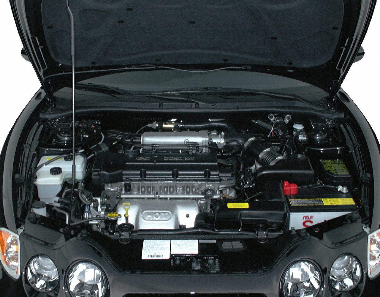 Engine bay and front headlights visible under open hood