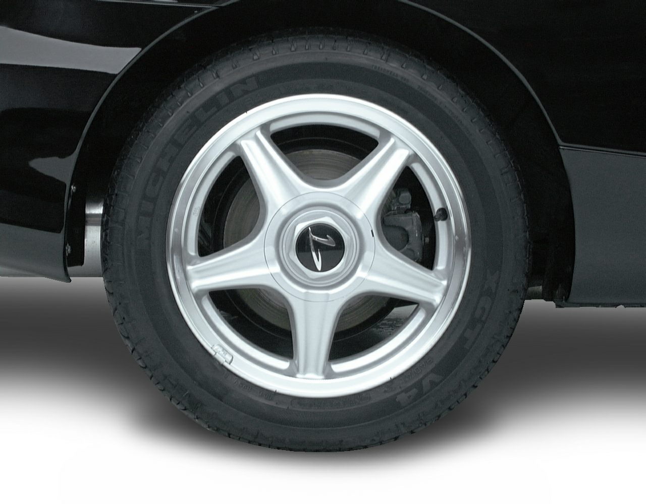 Silver 5-spoke alloy wheel with visible brake caliper and tire tread.