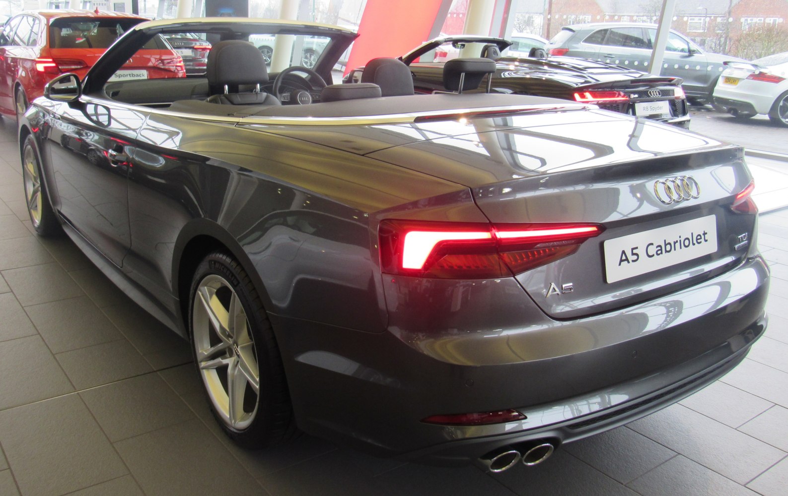 Sleek rear of convertible with LED tail lights and dual exhaust tips