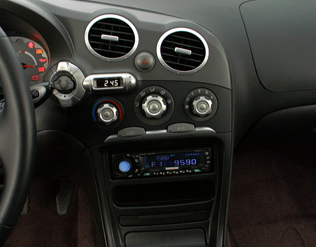 Round air vents, climate control knobs, and car stereo in car interior