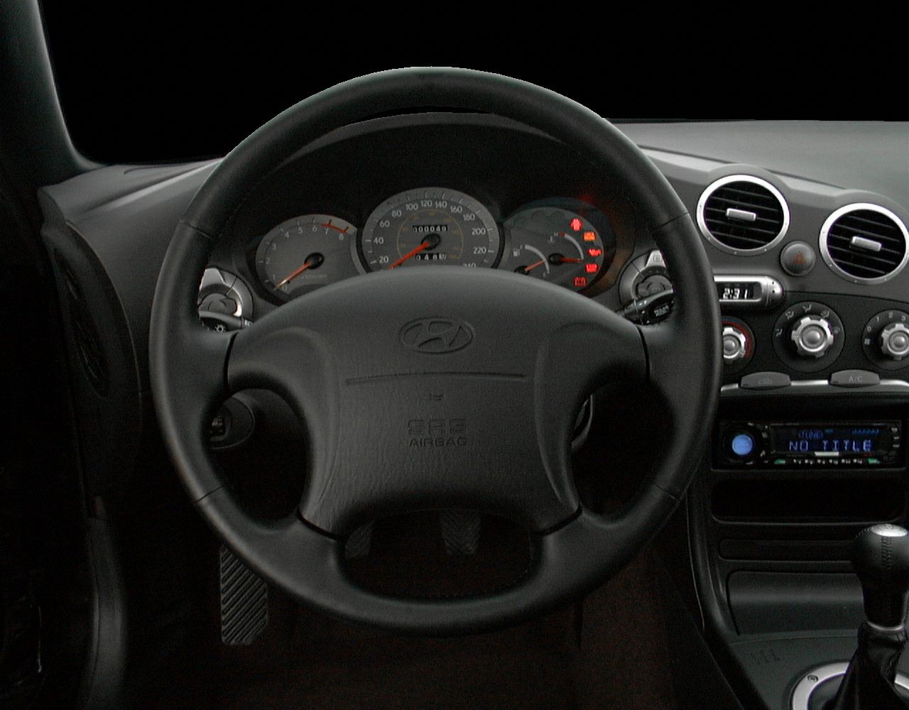 Dashboard with steering wheel, instrument cluster, and climate controls