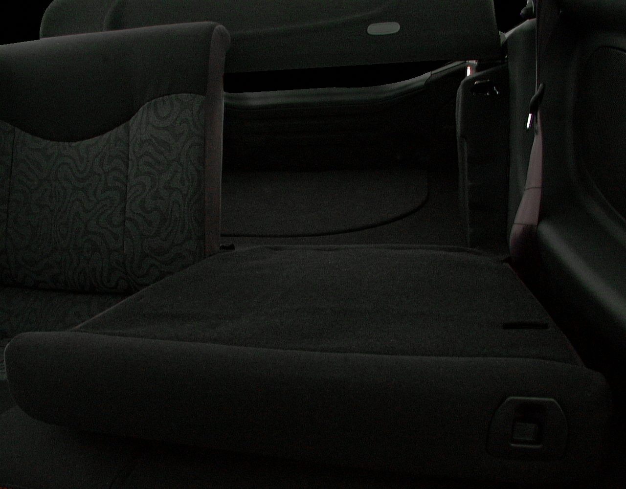 Folded rear seat and hatchback cargo area in car interior