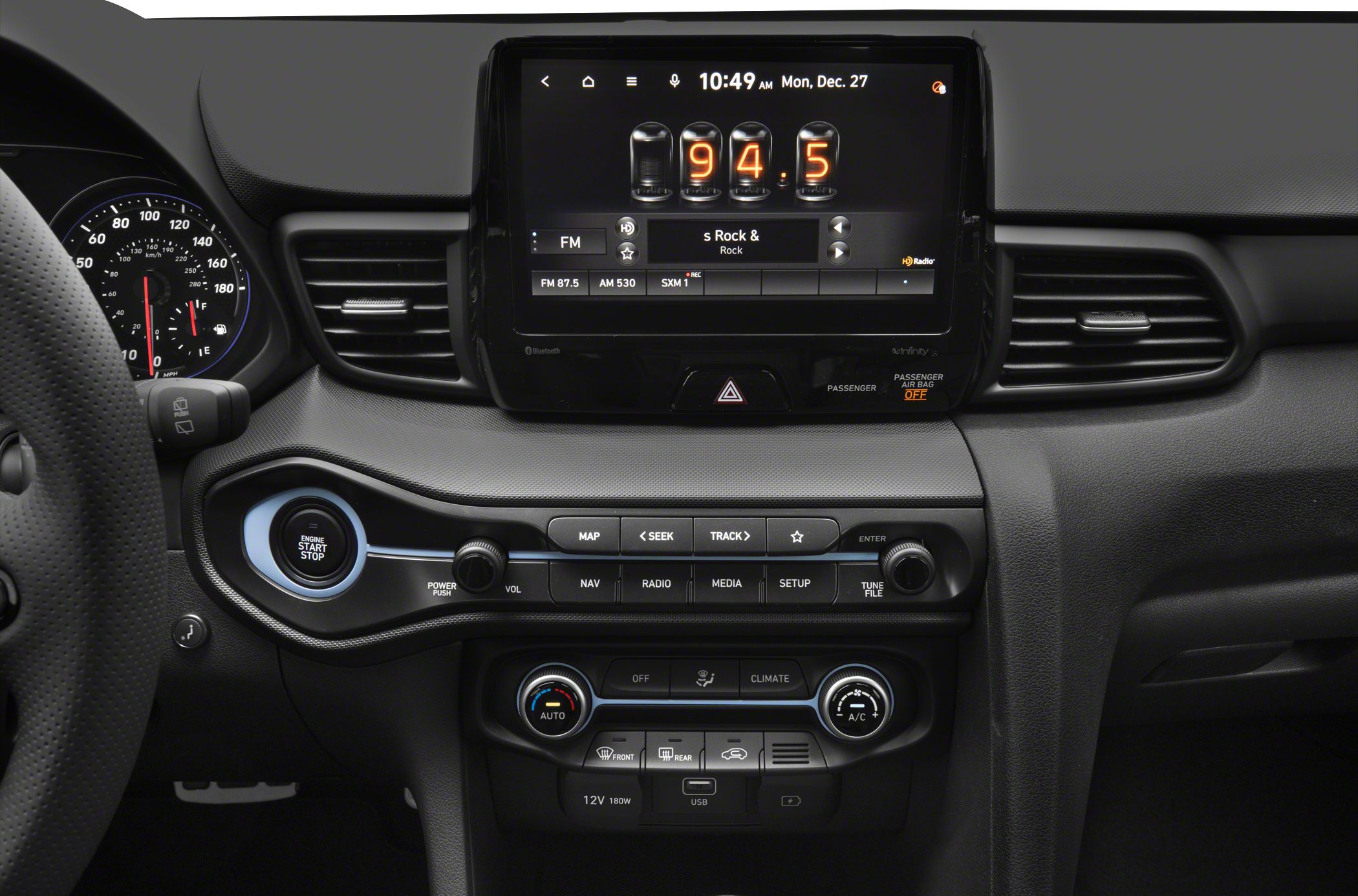 Digital infotainment display and dashboard controls with engine start button