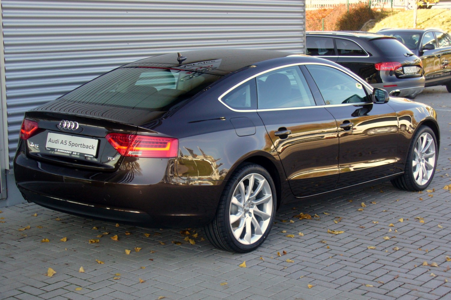 Rear view of a sleek 4-door hatchback with LED taillights and alloy wheels