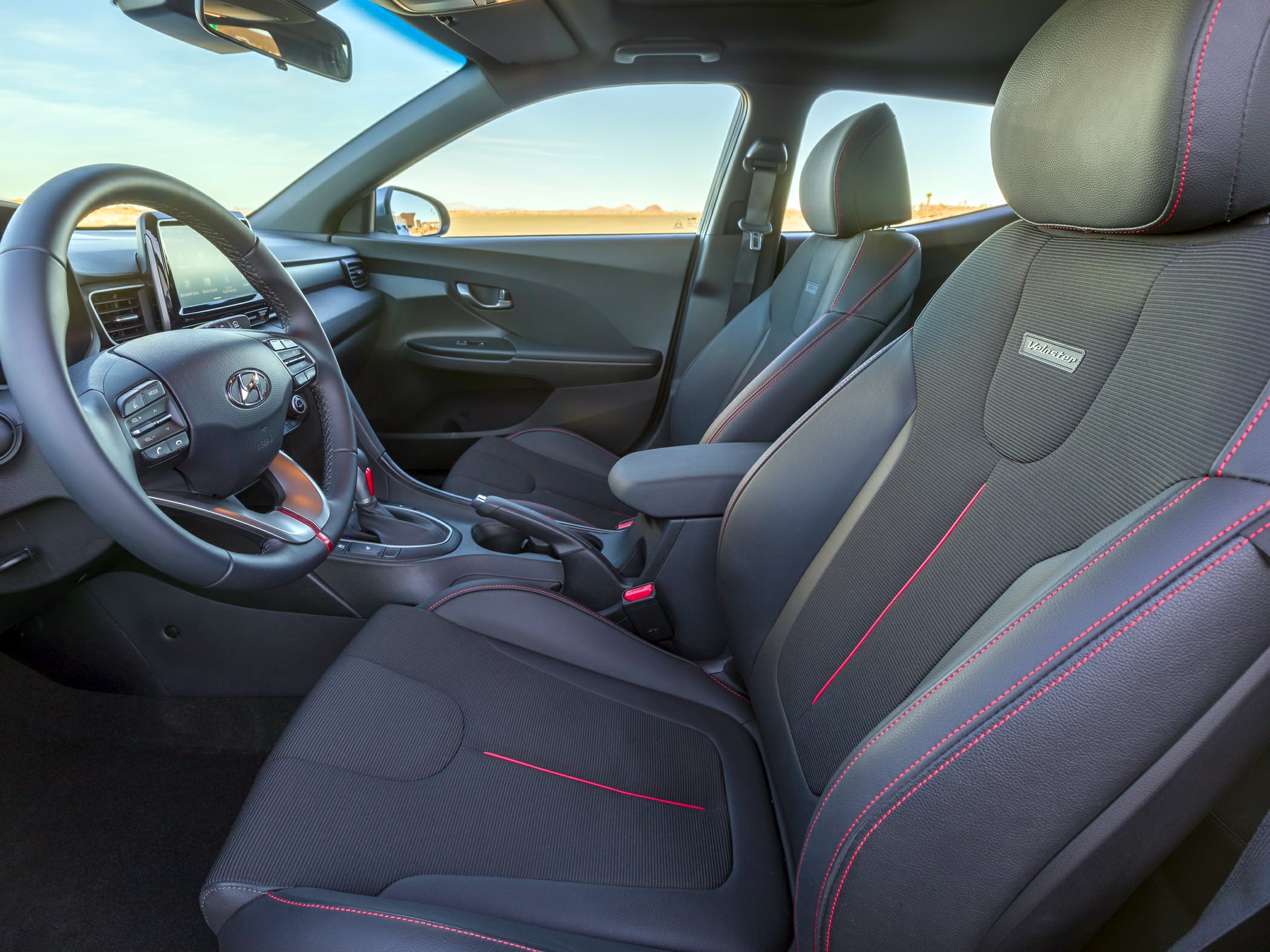Sporty black seats with red stitching and modern dashboard design.