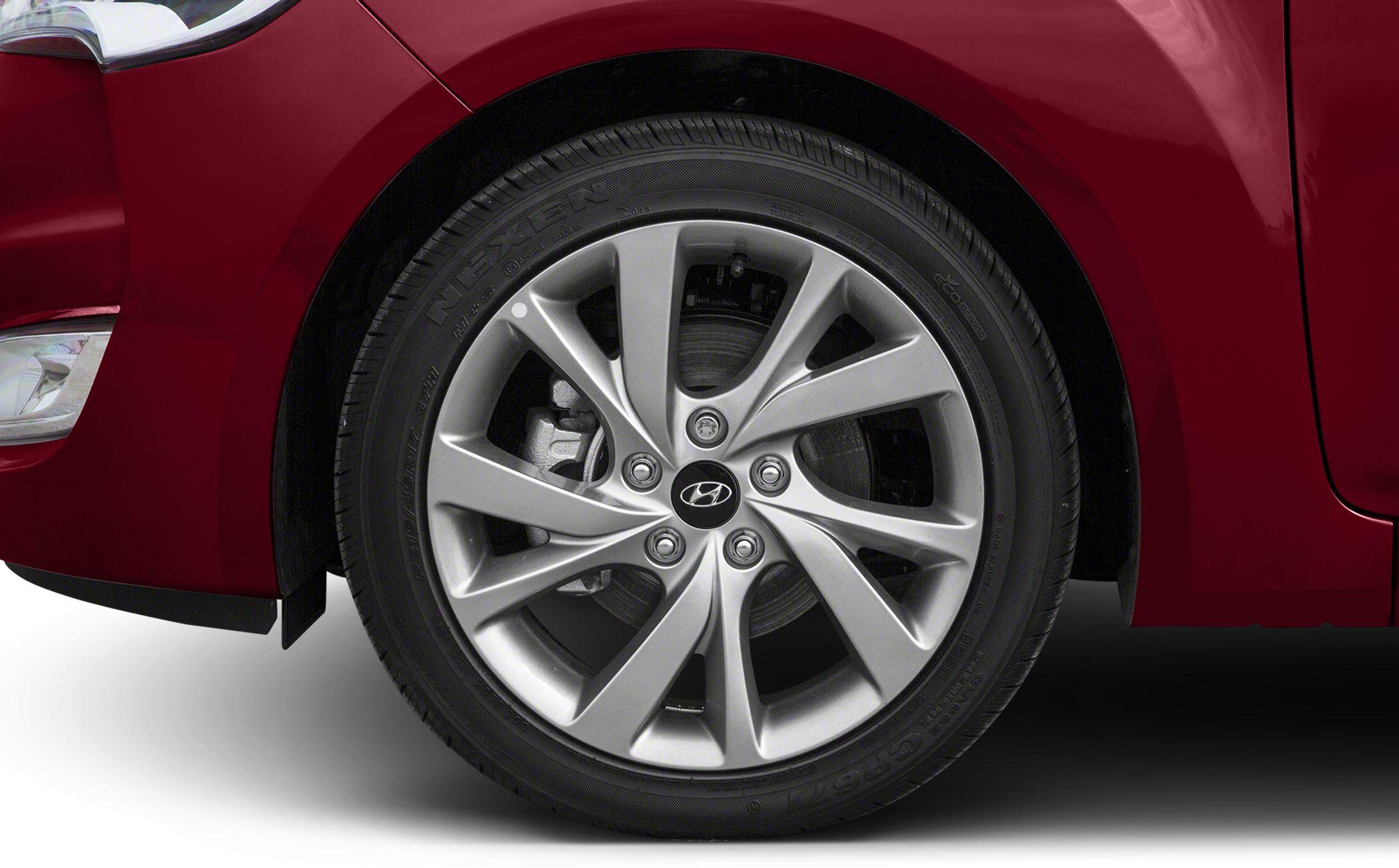 Alloy wheel with Nexen tire and adjacent red front fender close-up