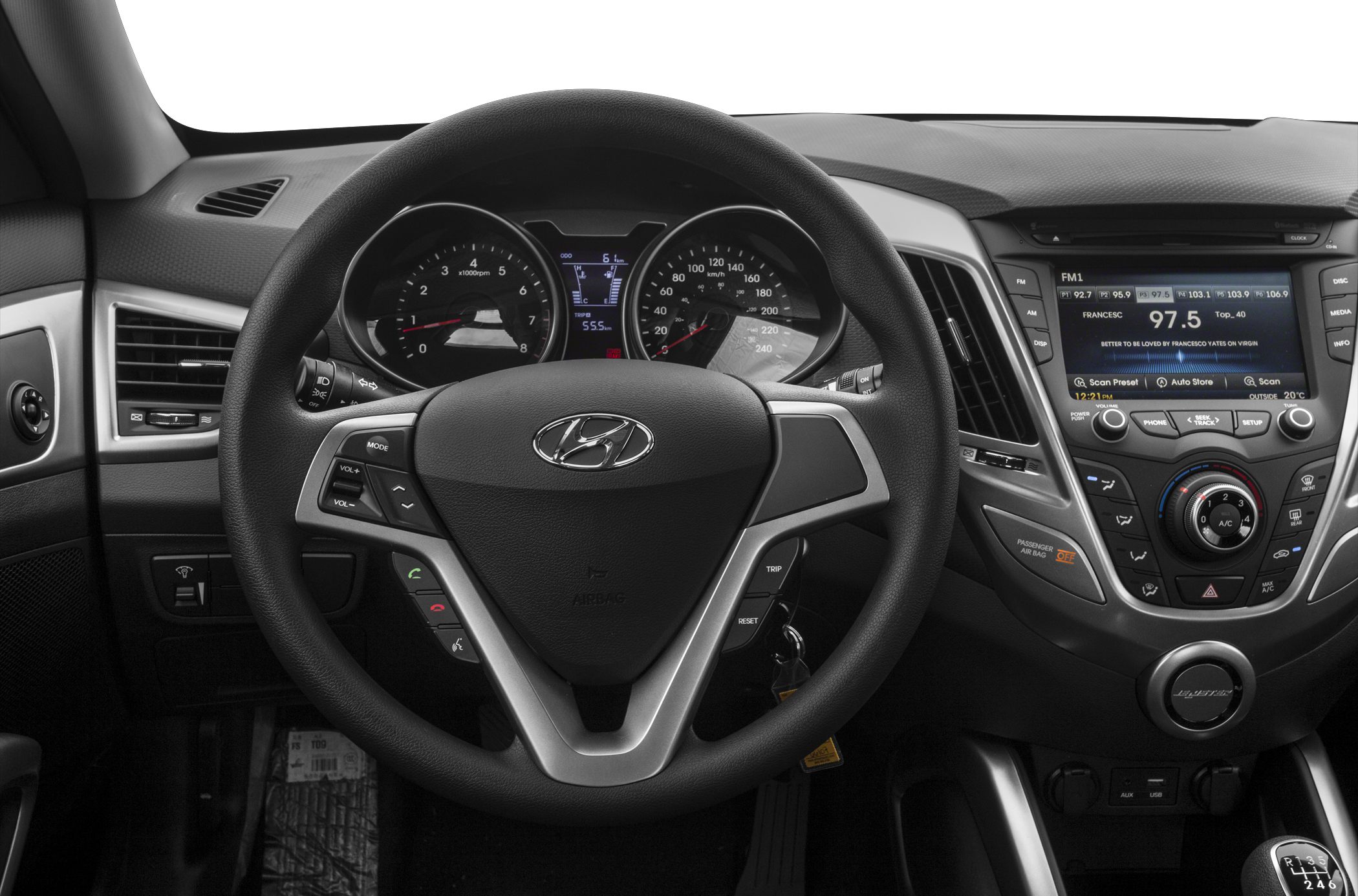 Steering wheel, dashboard gauges, and infotainment console.