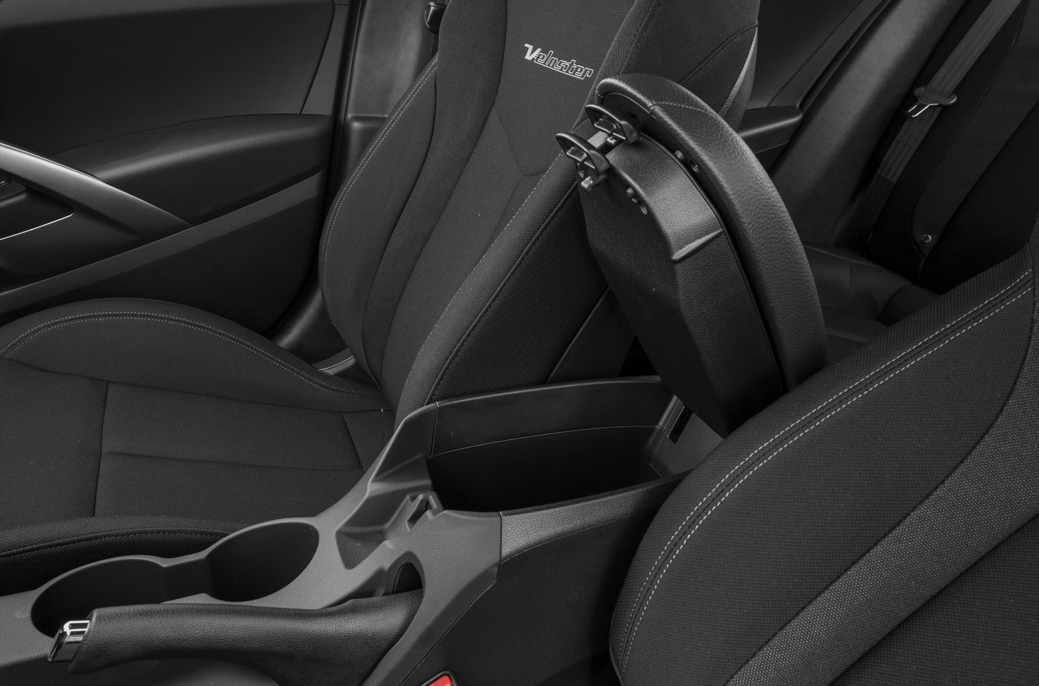Center console storage compartment and fabric seats with stitching