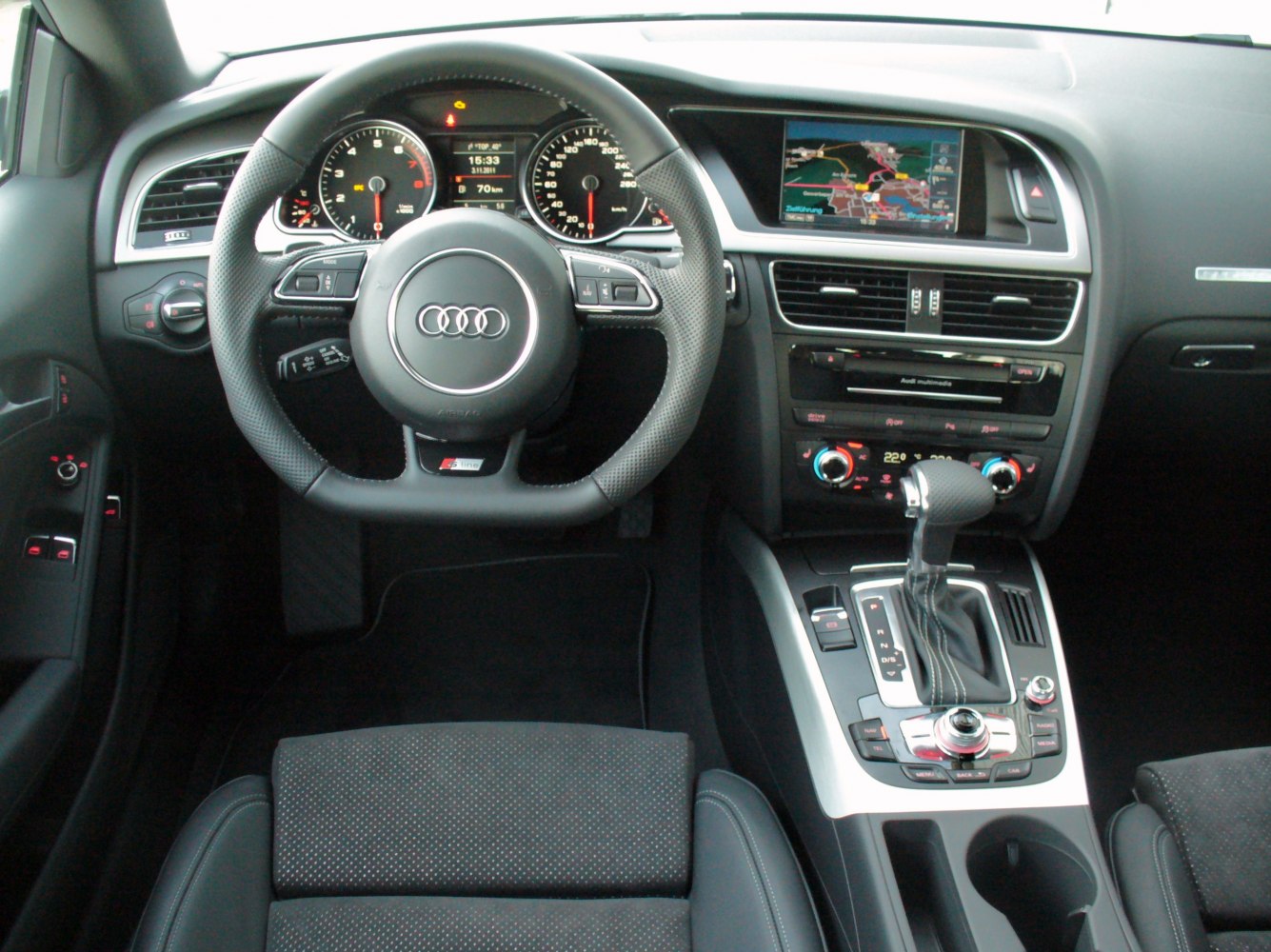 Audi A5 Coupe interior dashboard, steering wheel, multimedia display, and gear shifter
