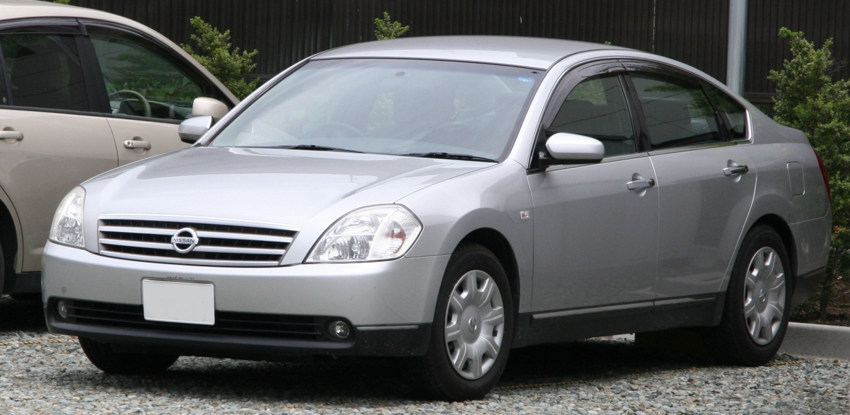 Silver sedan front and side with distinctive grille and headlights