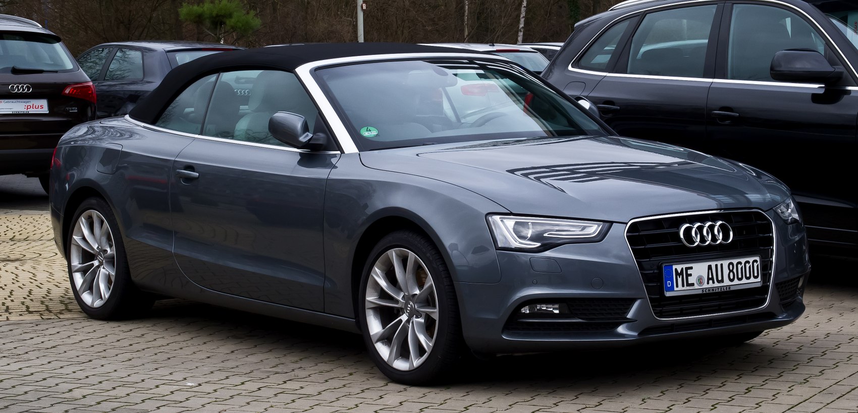Convertible coupe with folded soft top and alloy wheels