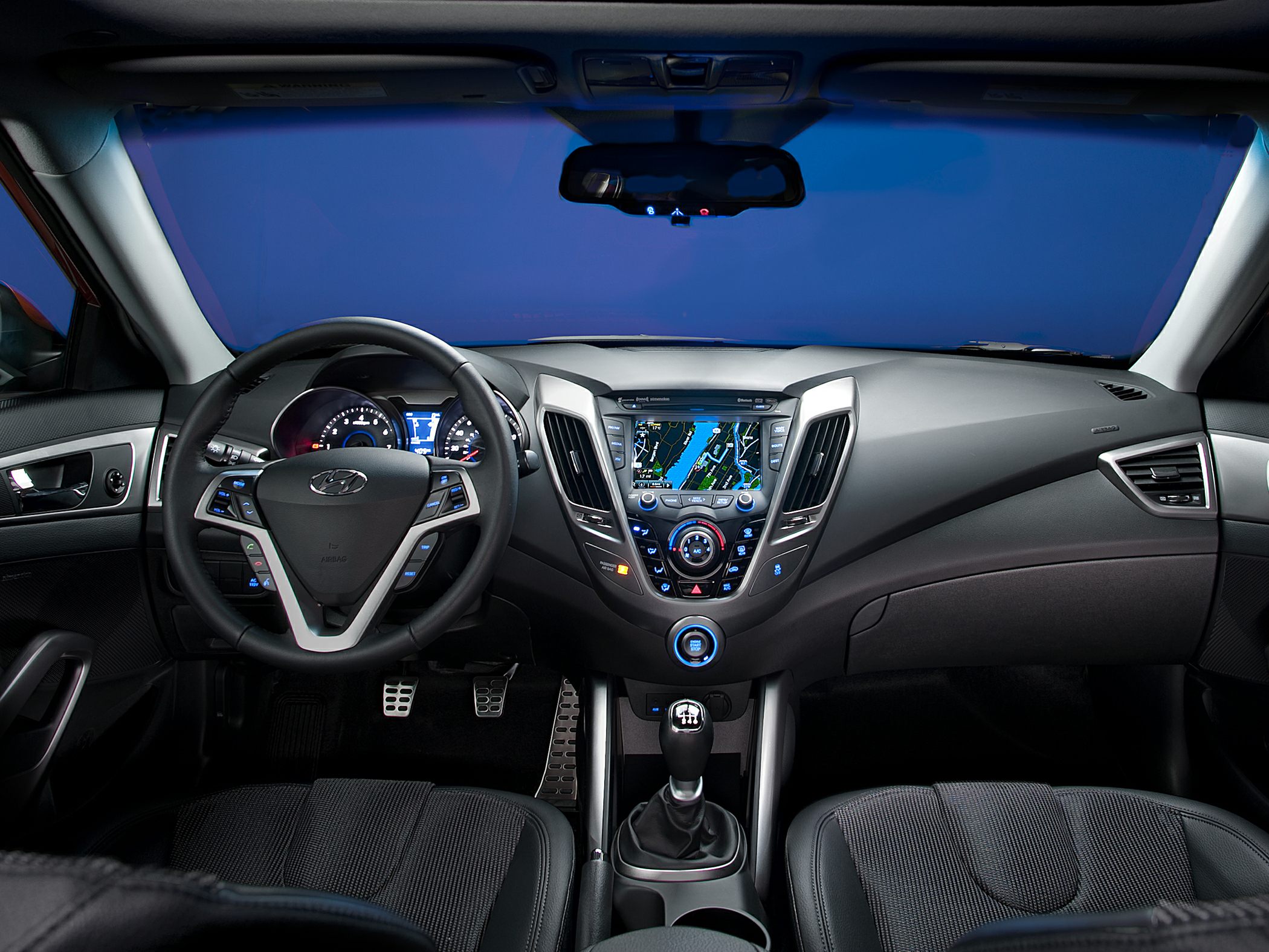 Interior dashboard with navigation screen and manual transmission gearshift