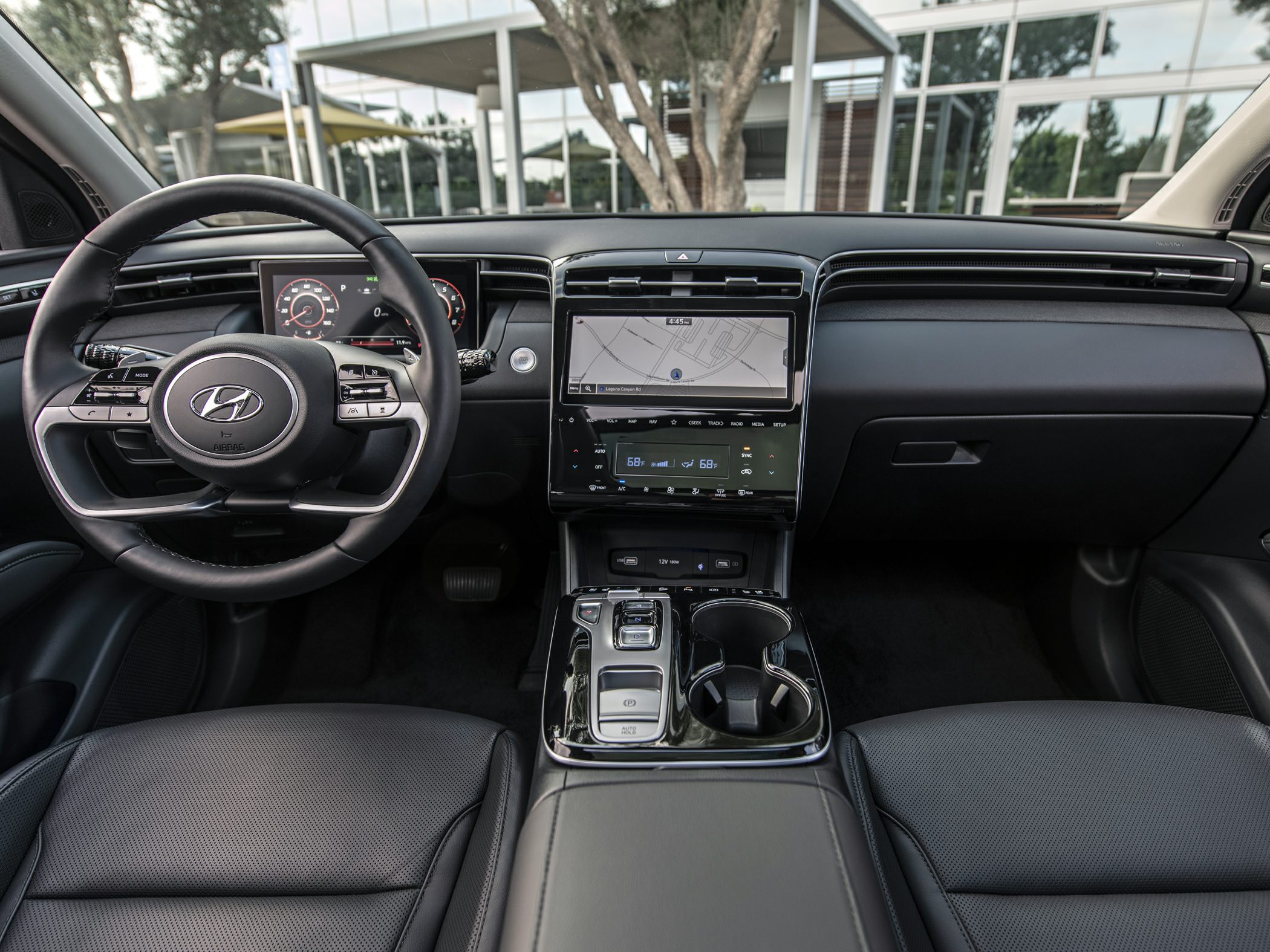 Digital dashboard and multifunction steering wheel with central touchscreen display.