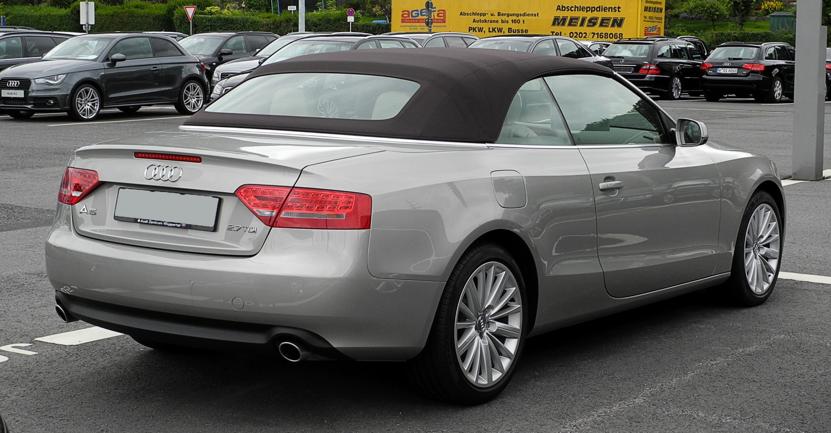 Rear view of a convertible with closed soft top and detailed taillights