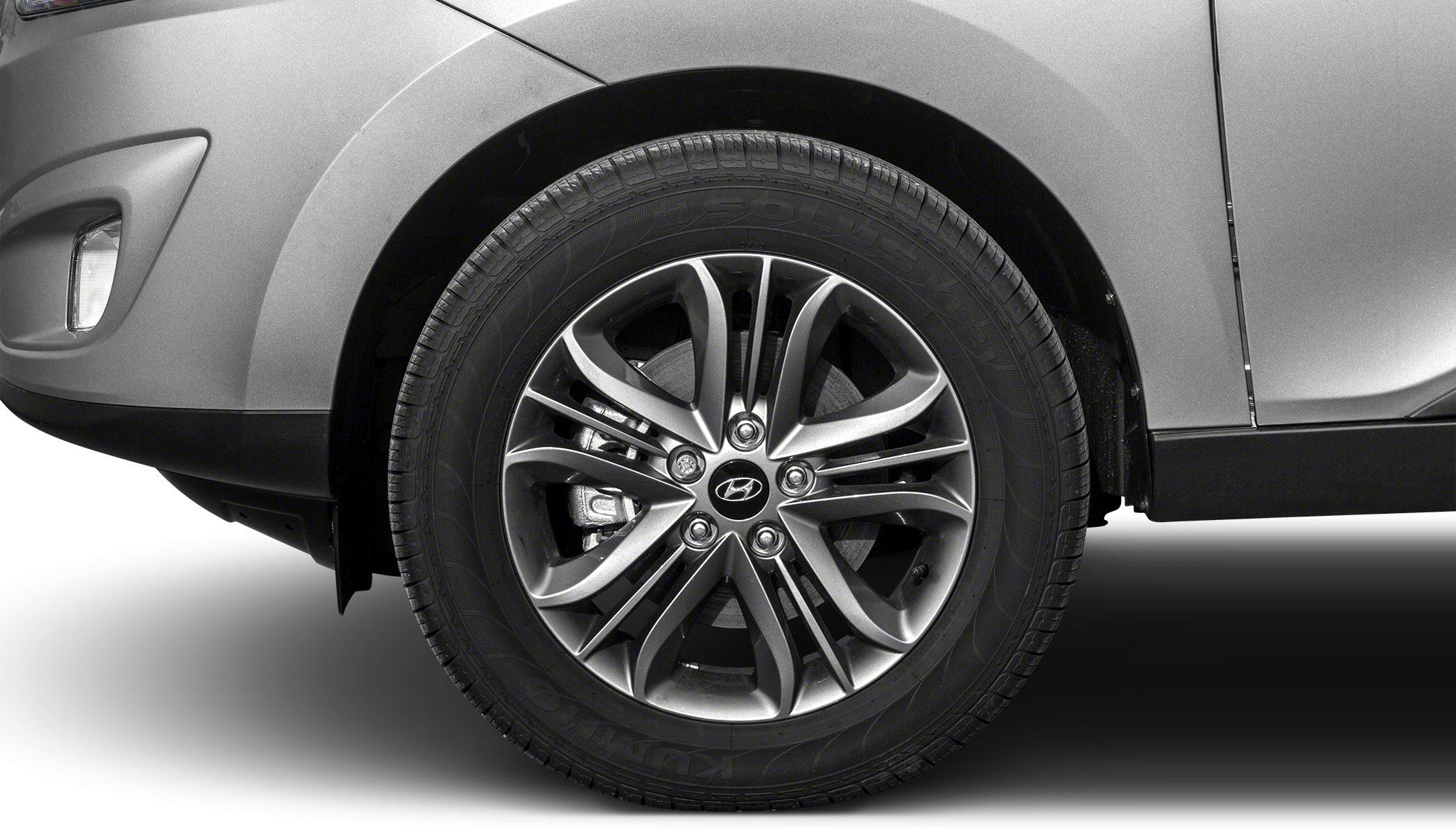 Detail of alloy wheel and front fender section of a vehicle.