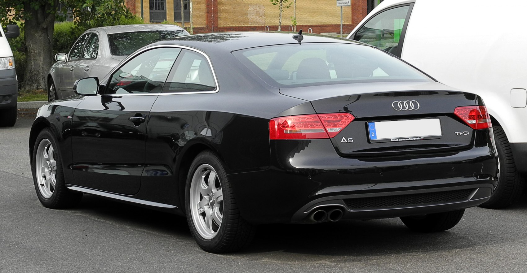 Rear view of black coupe with dual exhaust and distinct taillights