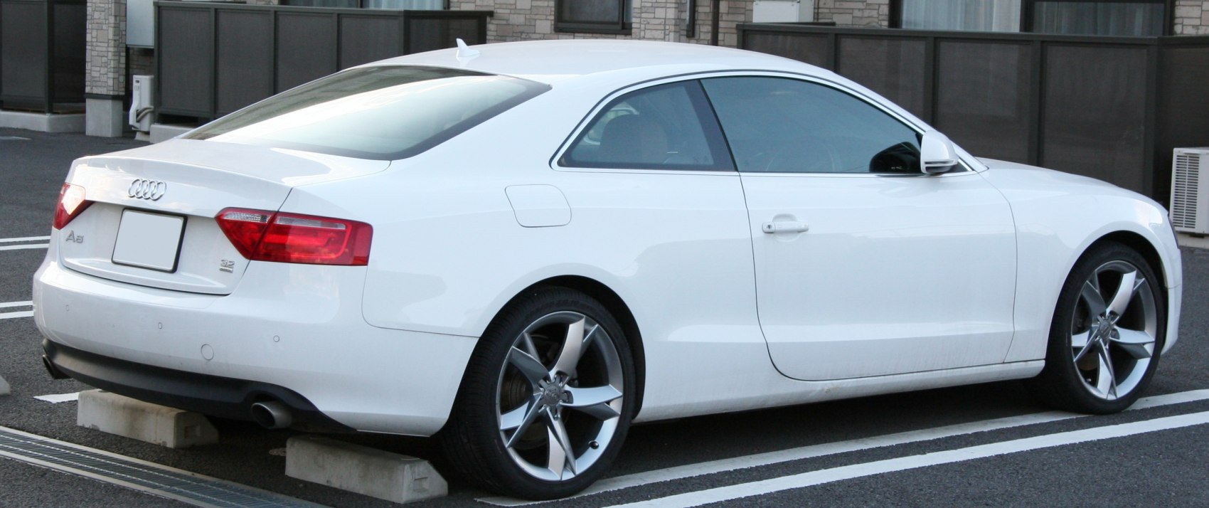 Rear side profile with taillights and alloy wheels