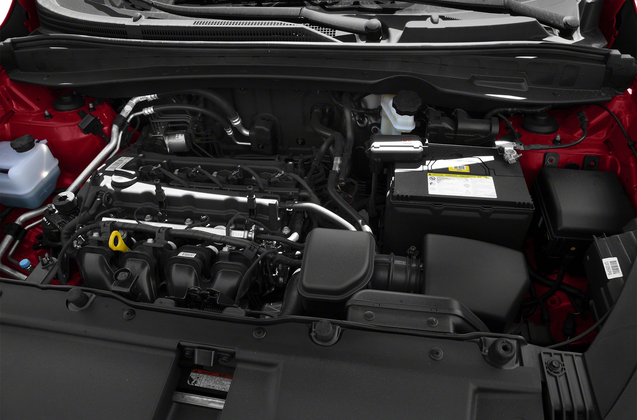 Close-up of engine bay with components and fluid reservoirs