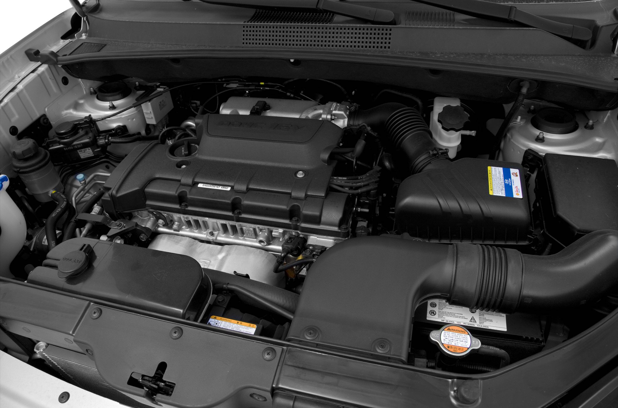 Close-up of a car engine bay with visible intake system and engine cover