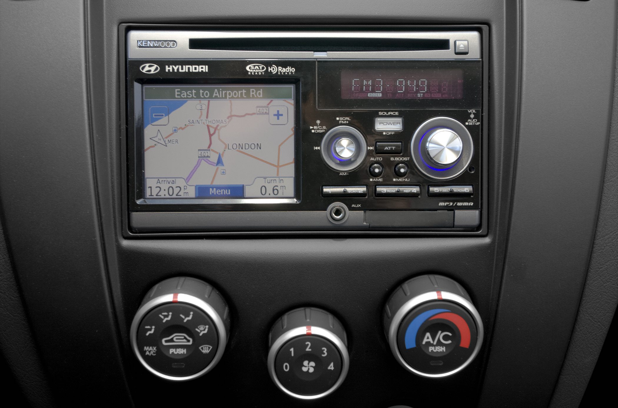 Kenwood navigation screen and three climate control knobs