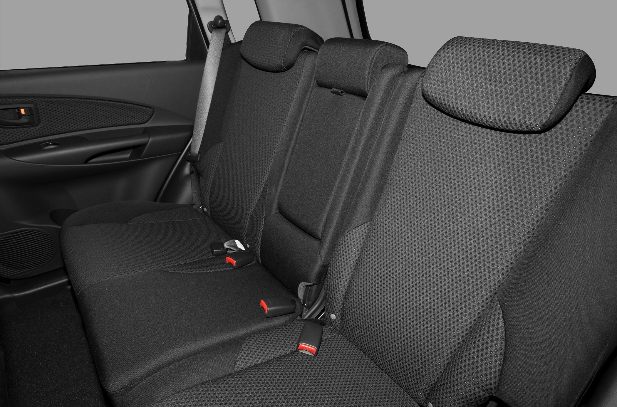 Black fabric upholstered rear seats with seatbelts and door panel.