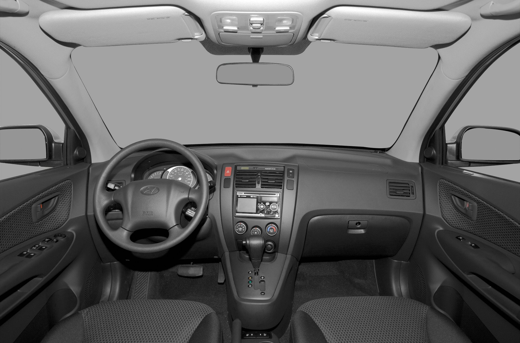 Dashboard, steering wheel, gear shift, and control panel layout.
