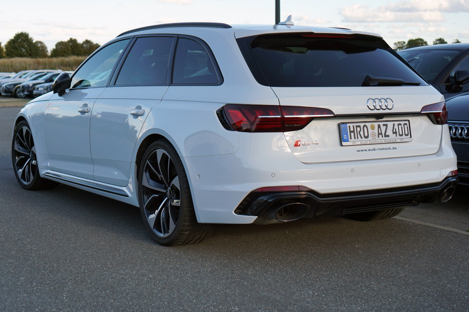 Rear view of white station wagon with LED taillights and black alloy wheels