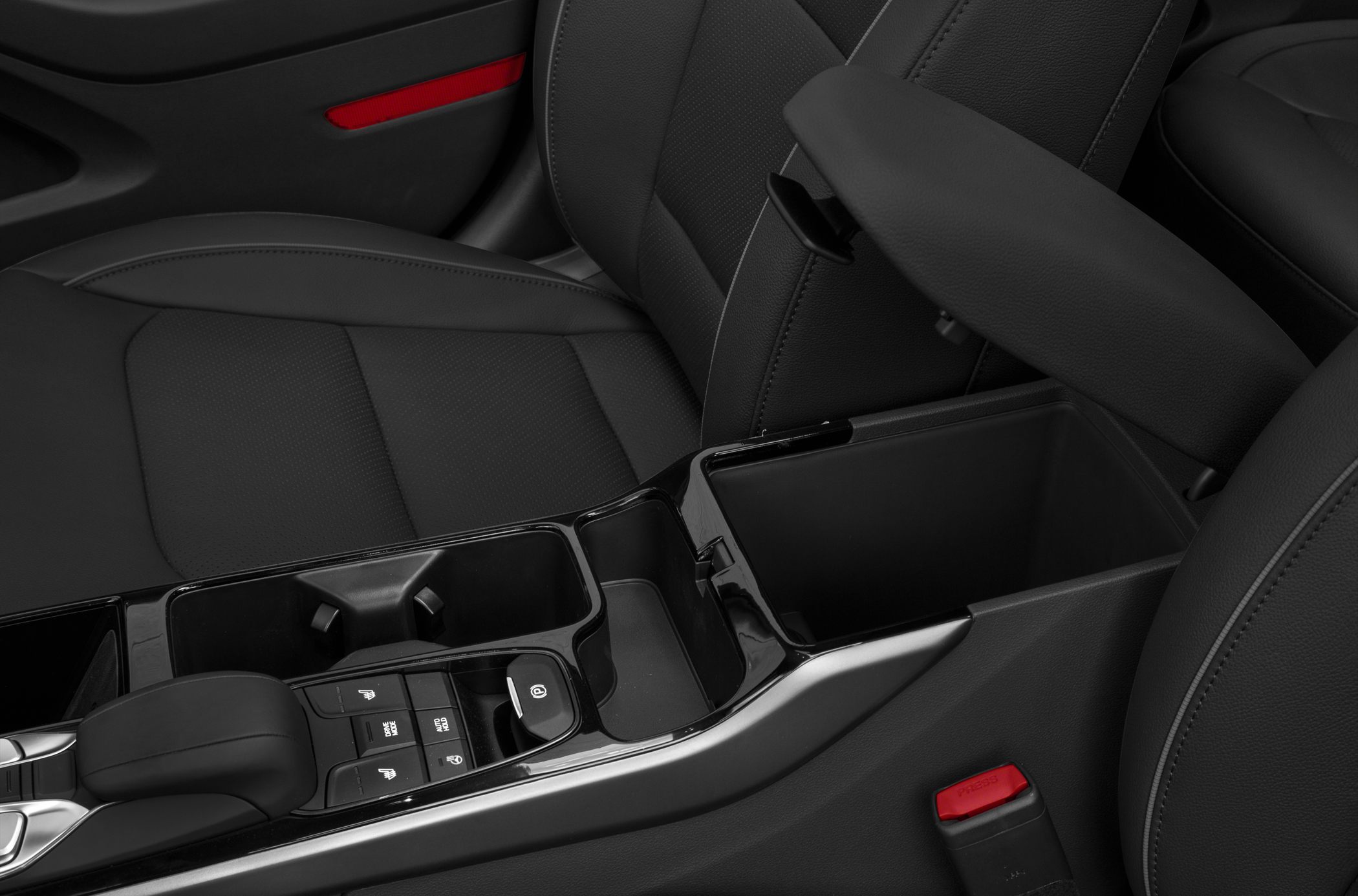 Center console with armrest and control buttons in car interior