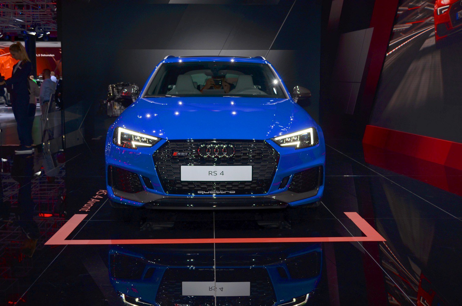 Blue car front with LED headlights and hexagonal grille
