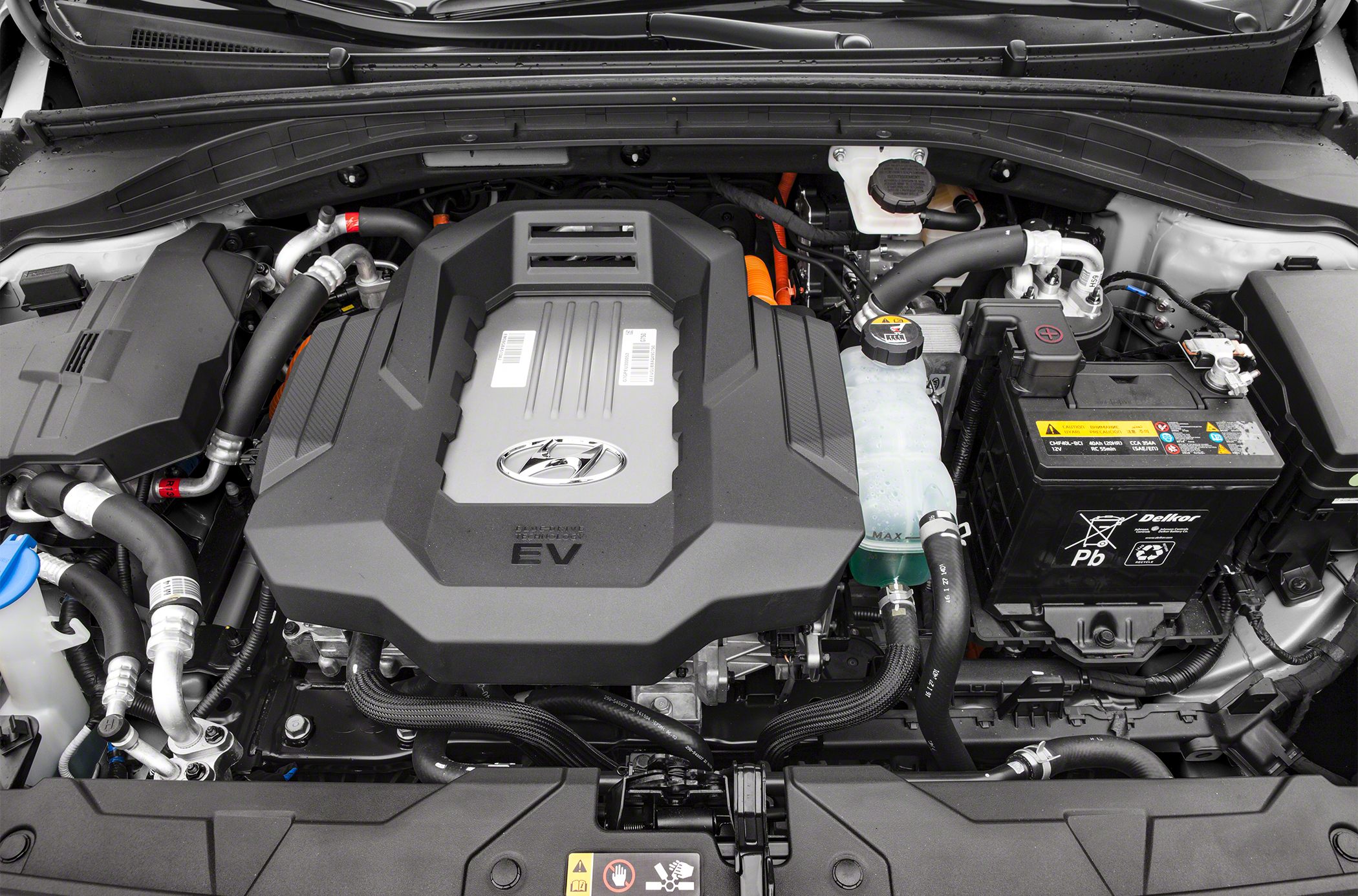 Electric vehicle engine bay with motor cover and battery pack