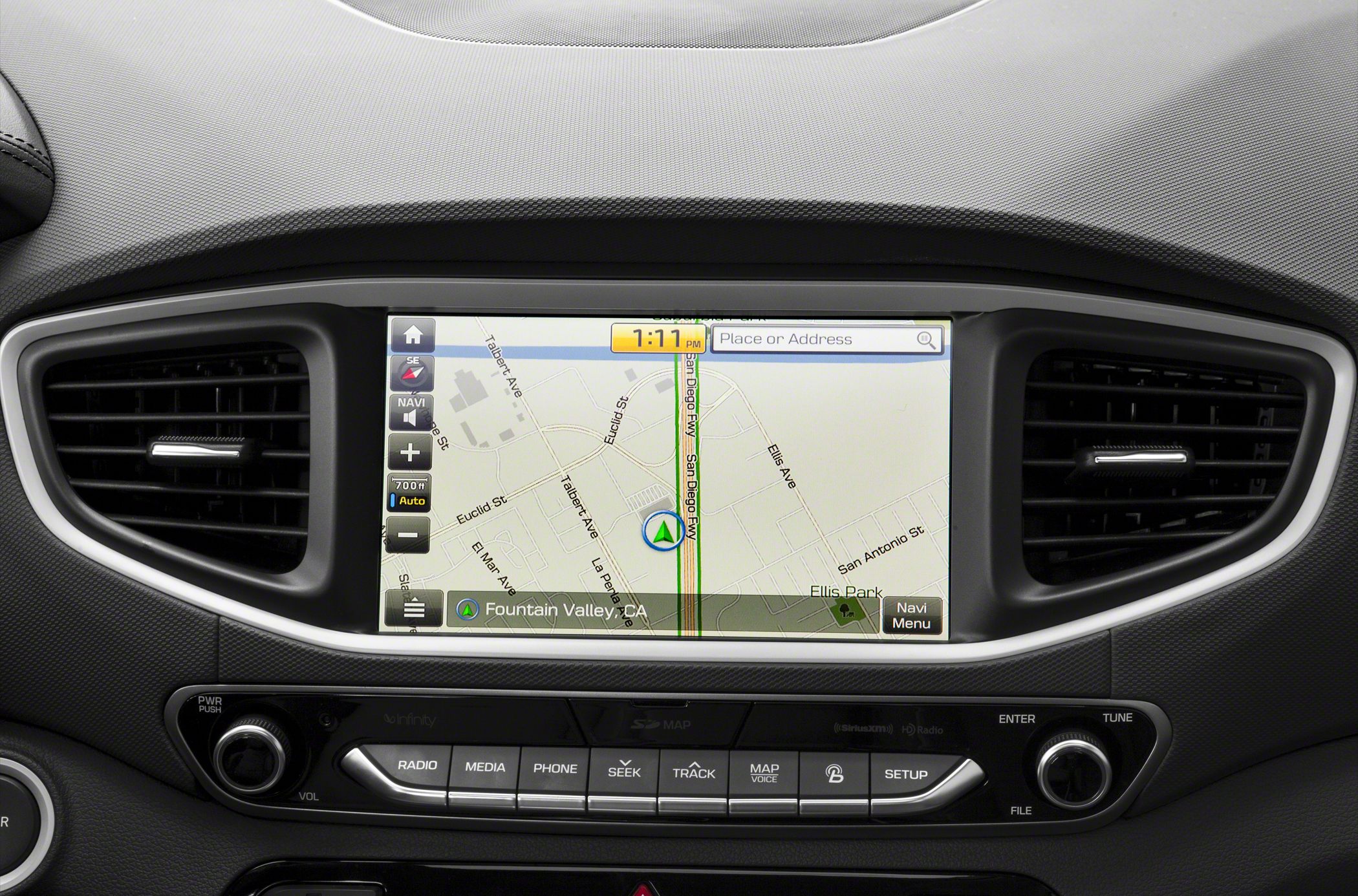 In-car navigation screen with media and phone control buttons on dash