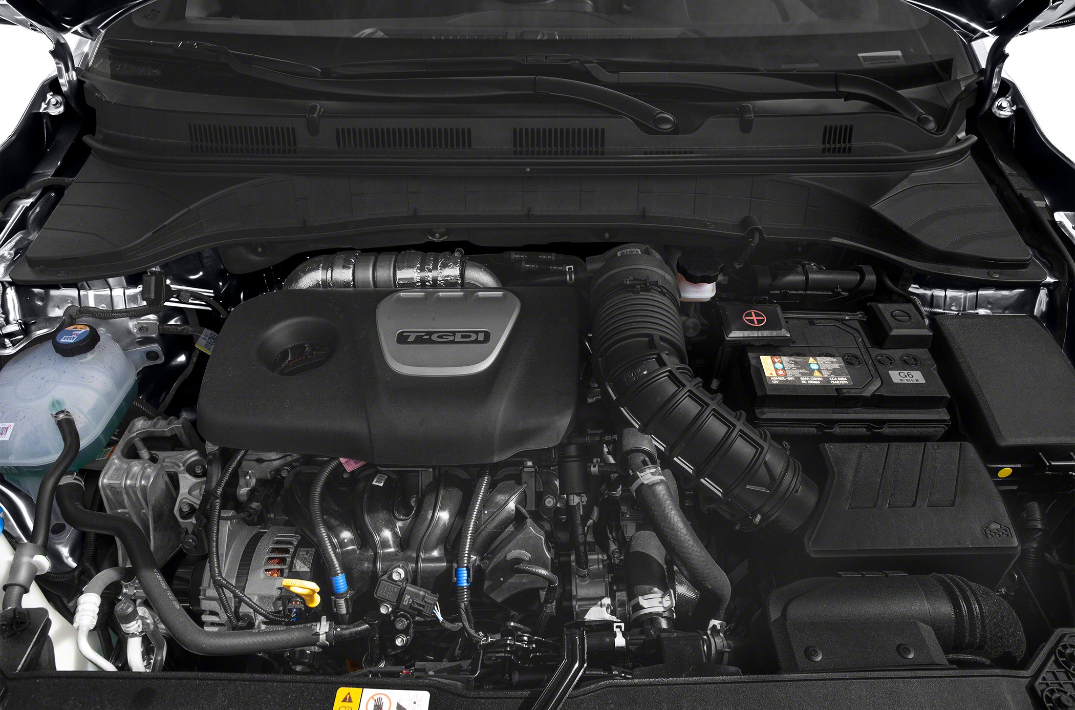 Turbocharged gasoline direct injection engine bay with visible air intake and battery components